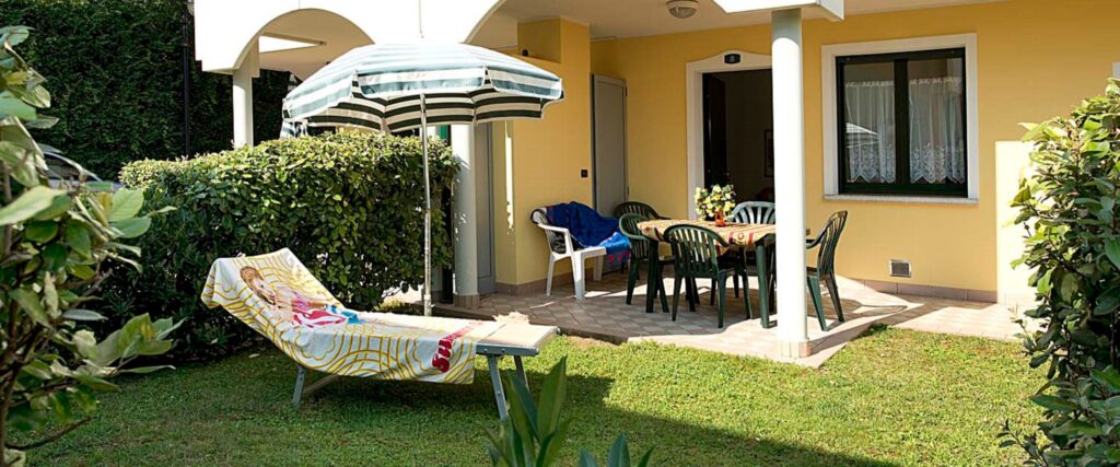 Patio esterno con sedie e ombrellone