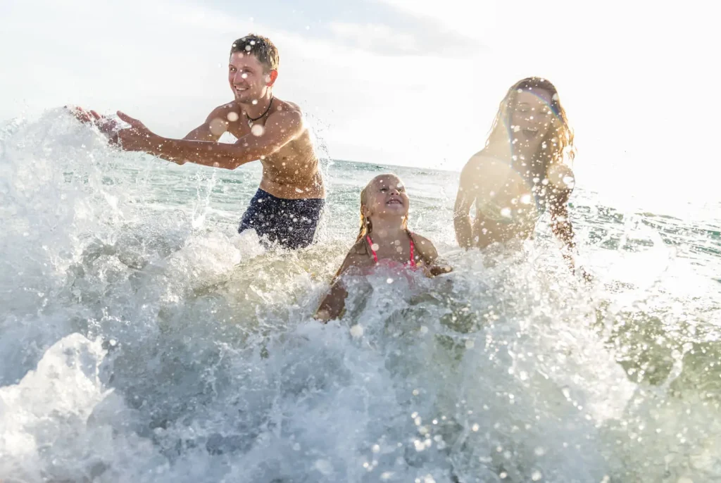 Famiglia gioca tra le onde del mare